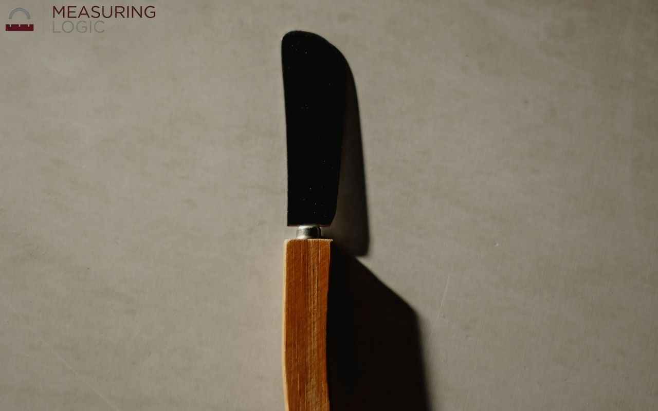 A butter knife lying on a marble surface