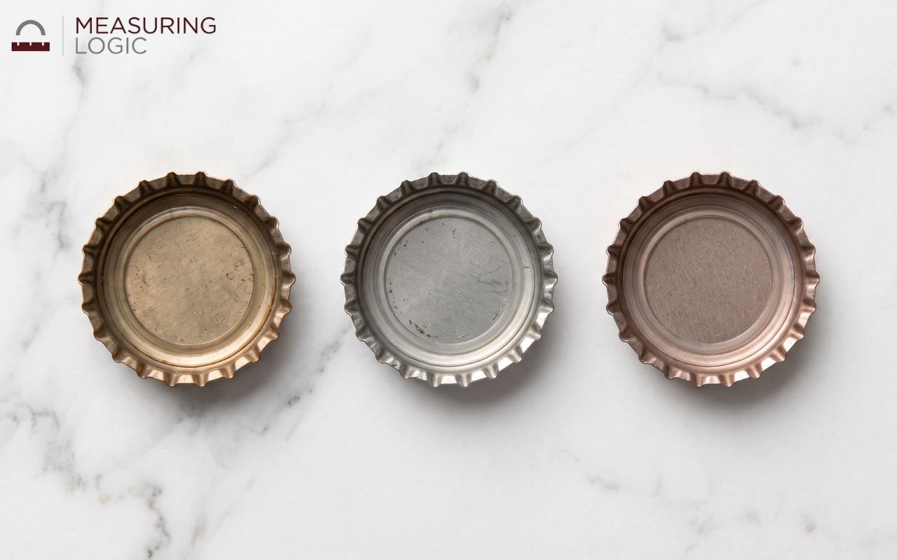 Three bottle caps side by side near 3 inches wide