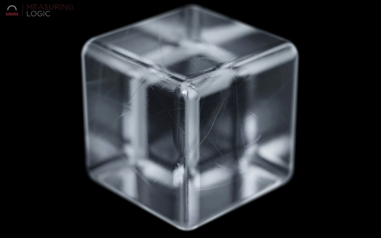 Clear ice cube on a black background, an example of an object about 1 inch per side