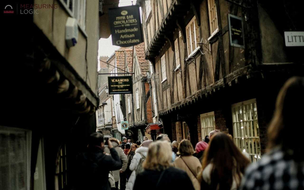 Crowded narrow street lined with shops