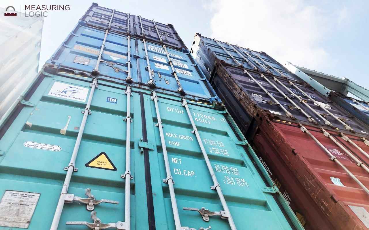 Low-angle view looking up at stacked shipping containers
