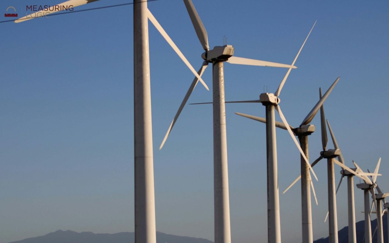wind turbines reaching toward the sky, with modern turbines reaching heights around 500 feet
