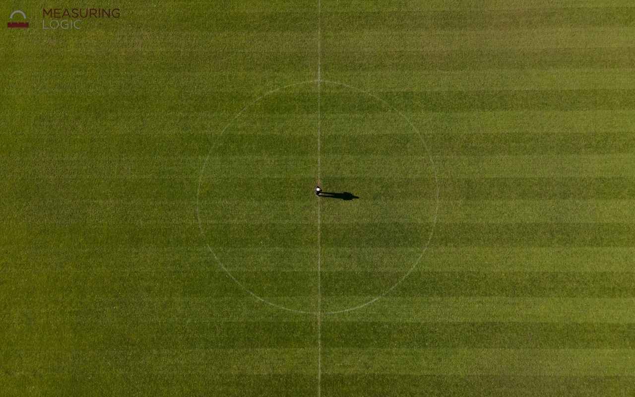 An aerial top-down view of a green soccer field.